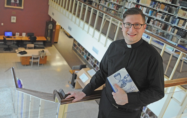 Deacon Cole Webster studies in the Christ the King Library as he prepares for his ordination at St. Joseph Catherdral on June 3. (Dan Cappellazzo/Staff Photographer)